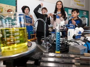Highlands and Rosslyn school students Adrien Hanna, left, Maddy Keown, Bradley Vith and Sofia Sejutee show their experiment on Thursday, Jan. 30, 2020, involving brine shrimp being sent to the International Space Station through the Student Spaceflight Experiment Program.