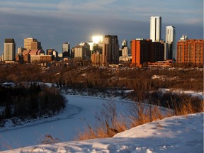 The sunrise shines off downtown office buildings, seen from Kinnaird Park near 77 Street and Jasper Avenue in Edmonton on Friday, Jan. 31, 2020.