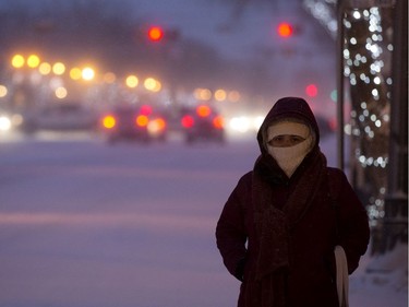 A woman waits for a bus along 82 Avenue near 104 Street, in Edmonton Thursday Jan. 16, 2020.