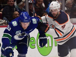 Edmonton Oilers defenceman Kris Russell (4) defends against Vancouver Canucks forward Bo Horvat (53) during the first period at Rogers Arena.