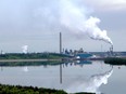 Syncrude Canada's base plant, located north of Fort McMurray, reflected in an ongoing reclamation project of a tailings pond, on Sunday, Aug. 11, 2019.