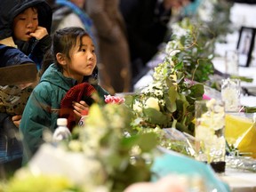 Flowers and photos of the victims set up at a memorial service at the University of Alberta for the victims of a Ukrainian passenger plane that crashed in Iran, in Edmonton, Alberta, Canada January 12, 2020.