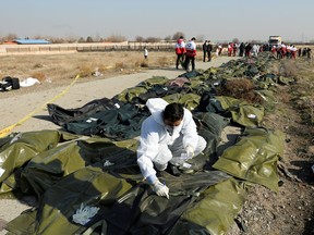 Passengers' bodies in plastic bags are gathered at the site where the Ukraine International Airlines plane crashed after take-off from Iran's Imam Khomeini airport, on the outskirts of Tehran, Iran January 8, 2020.