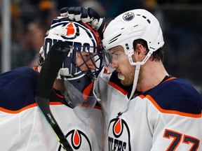 Edmonton Oilers goalie Mike Smith celebrates with defenceman Oscar Klefbom on Jan. 4, 2020, after defeating the Boston Bruins at TD Garden.