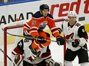 Edmonton Oilers Josh Archibald leaps in front of Arizona Coyotes goalie Antii Raanta and defenceman Jakob Chychrun during second period NHL hockey game action in Edmonton on Saturday January 18, 2020.