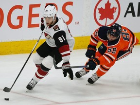 Arizona Coyotes Taylor Hall (left) eludes a check from Edmonton Oilers Sam Gagner during second period NHL hockey game action in Edmonton on Saturday January 18, 2020.