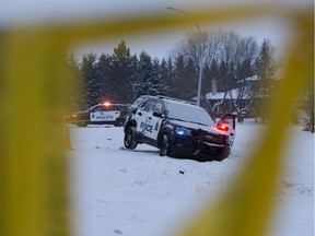 Police tape frames a damaged police vehicle near 25005 Sturgeon Road, north of Edmonton Monday Jan. 13, 2020