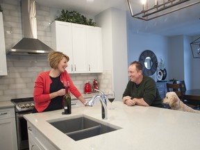 Rhonda and Corey Newman along with their dog, Kona, at their new home by Pacesetter Homes in Sherwood Park.