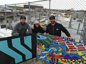 Marty Pawlina, left, and Kelsey Siemens of the Rohit Group of Companies, along with contest judge Jay Downton, hold signage on Tuesday, Jan. 7, 2019, to launch a competition called The Cut, giving away $125,000 to a new commercial tenant for the developing community of Stadium Yards.