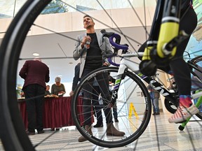 Tyler Mislawchuk, Canadian triathlete, pictured here through a bicycle wheel, spoke at the 2020 ITU Triathlon Grand Final official kicked-off, for this upcoming summer August 17-23, at City Hall in Edmonton, Jan. 27, 2020.