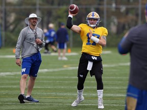 Buck Pierce works with QB Chris Streveler during practice last season. Pierce has been promoted to be the team's new offensive coordinator. Kevin King/Winnipeg Sun file