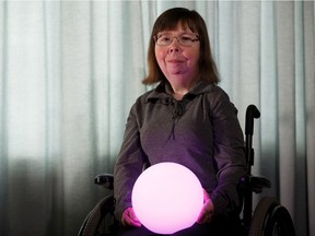 Choreographer Alison Neuman holds a glowing orb, a prop in The Strike, a dance performance debuting as part of the Chinook Series.