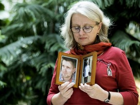 Petra Schulz holds photos of her son Danny Schulz after taking part in a press conference where the Alberta government announced over $700,000 in funding to establish safe drug consumption sites, at the Royal Alexandra Hospital in Edmonton on Thursday Oct. 27, 2016. Danny Schulz died of a fentanyl overdose April 30, 2014.