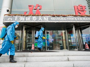 Medical workers spray antiseptic outside of the main gate of Shanghai Stock Exchange Building on Feb. 3, 2020 in Shanghai, China.