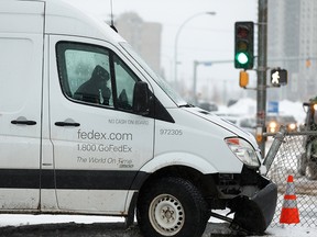 A FedEx truck struck a fence in the middle of 112 Avenue at Stadium Road in Edmonton, on Tuesday, Feb. 11, 2020. Slippery conditions and snowfall created difficult driving conditions across much of the city. Photo by Ian Kucerak/Postmedia