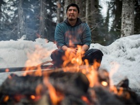 Johnny Morris, of the Wet'suwet'en First Nation, sits by a fire at the Unist'ot'en camp near Houston, B.C., on Thursday January 17, 2019.