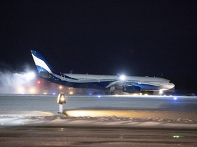 A plane carrying 176 Canadian citizens from the centre of the global novel coronavirus outbreak in Wuhan, China, lands at CFB Trenton, in Trenton, Ont., on Friday, Feb. 7, 2020. THE CANADIAN PRESS/Justin Tang
