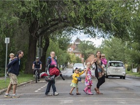 EDMONTON, AB. AUGUST 5, 2015 -From left, Kurtis Kindarkewich, and Kiptyn, Anastasia,  and baby Reese. and Julie Kusiek with her daughters  Noelle, Felicity and Cherise. Kusiek and her neighbours are leading an effort to improve the walking, cycling and living experience on 106 Street and 76 Avenue, while still letting the roads carry vehicle traffic.