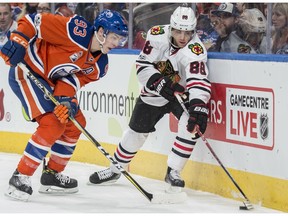 Ryan Nugent-Hopkins (93) of the Edmonton Oilers battles for the puck against Patrick Kane of the Chicago Blackhawks in Edmonton on Feb. 11, 2017.