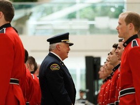 Fire Chief Ken Block (centre) reviews Recruit Class 150 members in the final graduation ceremony under his tenure in June 2019. Ian Kucerak/Postmedia