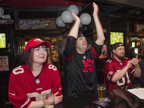 San Francisco fans Vesna Vorih, left, Brian Campbell and Garrett Hill watch the Super Bowl at the downtown location of The Pint on Sunday, Feb. 2, 2020.