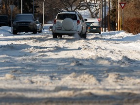 Uncleared and rutted snow is seen covering 102 Avenue near 88 Street in Edmonton on Feb. 3, 2020. The city is beginning a residential blading cycle Monday.