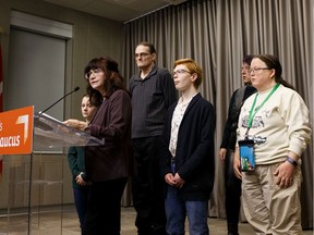 Marie Renaud (second from left), NDP Official Opposition Critic for Community and Social Services, speaks alongside disabled Albertans receiving income supports about government cuts to transportation payments during a press conference at the Federal Building in Edmonton, on Thursday, Feb. 6, 2020.