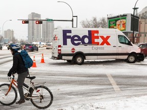 A FedEx truck struck a fence in the middle of 112 Avenue at Stadium Road in Edmonton, on Tuesday, Feb. 11, 2020. Slippery conditions and snowfall created difficult driving conditions across much of the city.