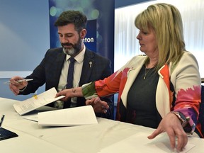 Exchanging paperwork as Mayor Don Iveson and City of St. Albert Mayor Cathy Heron offficially signing the Intermunicipal Collaboration Framework on funding and delivering recreation services to residents between the two cities, in Edmonton, February 13, 2020. Ed Kaiser/Postmedia