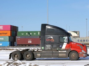 A lift machine moves shipping containers at the CN Calgary Logistics Park near Conrich on Friday, Feb. 14, 2020.