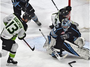 Edmonton Oil Kings Riley Sawchuk (13) fires the puck at Winnipeg Ice goalie Liam Hughes (30) as Carter Souch (44) crash into the net during WHL action at Rogers Place in Edmonton, February 25, 2020.