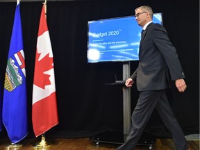 Finance Minister Travis Toews walks to the podium to speak to the media on the 2020 budget at the embargoed news conference in Edmonton on Thursday, Feb. 27, 2020.
