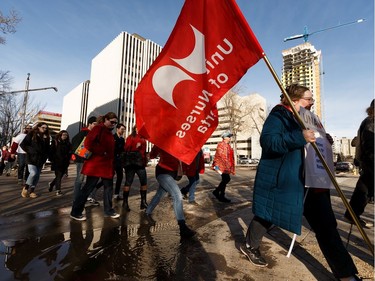Teachers, union members and supporters walk along 108 Street as they rally against the 2020 Alberta Budget during a march from downtown Edmonton to the Alberta Legislature on Thursday, Feb. 27, 2020. The budget was unveiled today by Alberta's United Conservative Party government.