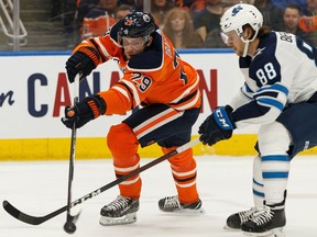 Edmonton Oilers' Leon Draisaitl (29) battles Winnipeg Jets' Nathan Beaulieu (88) during first period NHL hockey action at Rogers Place in Edmonton, on Saturday, Feb. 29, 2020. Photo by Ian Kucerak/Postmedia