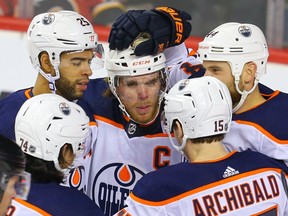 Edmonton Oilers' Zack Kassian, right, celebrates with teammates after scoring a goal against the Calgary Flames in Calgary on Saturday, Feb. 1, 2020.