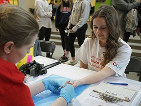 Blood recipient Rachelle Drummond, right, goes through a test to check her blood type at the University of Alberta on February 4, 2020. Canadian Blood Services was hosted blood typing events across the country to encourage students to become blood donors.