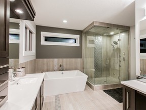 This City Homes master ensuite includes a soaker tub and spa-style shower with multiple heads.