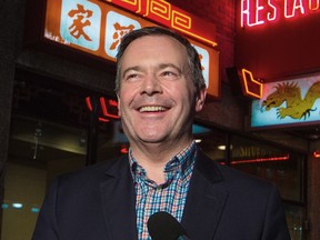 Alberta Premier Jason Kenney talks with reporters before having dinner at a restaurant in Calgary's Chinatown on Feb. 1, 2020. Kenney wanted to reassure Albertans that the risk of getting the coronavirus is very low.