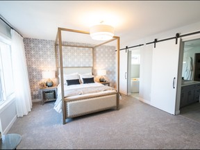 Extra details in a master bedroom, such as barn doors to the ensuite, add character.