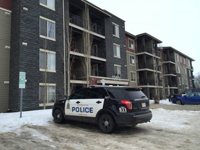 An Edmonton police cruiser is parked outside a northeast Edmonton condo building on Sunday, Feb. 9, 2020. A 32-year-old man was found dead in one of the units overnight Sunday. Police are treating his shooting death as suspicious.