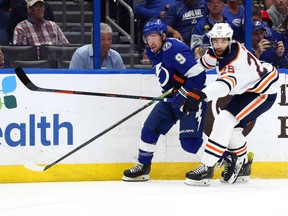 Tampa Bay Lightning centre Tyler Johnson (9) and Edmonton Oilers centre Leon Draisaitl (29) fight to control the puck at Amalie Arena.