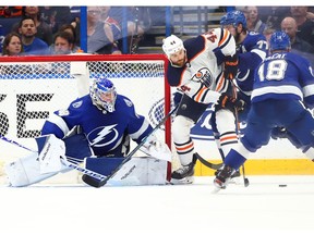 Edmonton Oilers right wing Zack Kassian (44) skates with the puck as Tampa Bay Lightning left wing Ondrej Palat (18) defends and goaltender Andrei Vasilevskiy (88) looks on during the third period at Amalie Arena on Feb. 13, 2020.