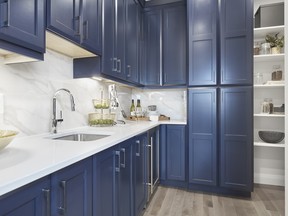 Integrated cabinets hide the entrance to the walk in pantry  in the Pinnacle show home in Edgewater by Jayman Built.