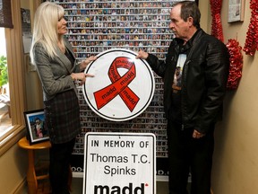 Gillian Phillips (left), MADD Canada Victim Services Manager-Western Region, and Tony Wentworth unveil roadside memorial signs honouring the memory of Wentworth's son Thomas Spinks, who died in an alcohol-related crash on October 23, 2017, at MADD Edmonton & Area Chapter's office in Edmonton, on Wednesday, Feb. 5, 2020. The signs will be placed near the 41st Avenue overpass near the southern entrance to the city.