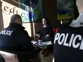 RCMP members chat with members of the public during the first Mochas with Mounties event at the Leduc Coffee Shop, in Leduc Thursday Feb. 20, 2020.