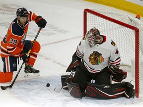 Chicago Black Hawks goalie Robin Lehner (right) makes a save on Edmonton Oilers forward Alex Chiasson in Edmonton on Tuesday ,Feb. 11, 2020.