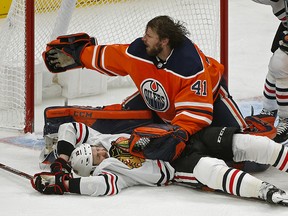 Edmonton Oilers goalie Mike Smith throws Chicago Black Hawks Zack Smith to the ice during NHL hockey game action in Edmonton on Tuesday February 11, 2020. (PHOTO BY LARRY WONG/POSTMEDIA)