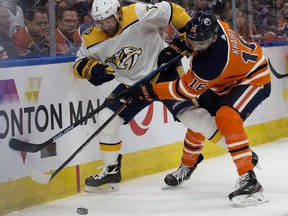 The Edmonton Oilers' Jujhar Khaira (16) battles the Nashville Predators' Yannick Weber (7) during third period NHL action at Rogers Place, in Edmonton Saturday Feb. 8, 2020. The Oilers won 3-2. Photo by David Bloom
