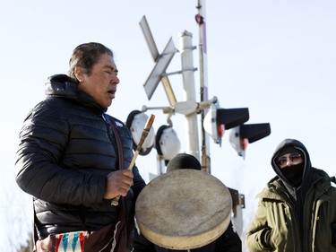 A drummer sings as protesters block the CN rail line near 213 Street and 110 Avenue in solidarity with Wet'suwet'en Hereditary Chiefs, in Edmonton Wednesday Feb. 19, 2020.