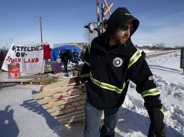 A counter protesters tear down a blockade along the CN rail line near 213 Street and 110 Avenue, in Edmonton Wednesday Feb. 19, 2020. A separate group of protesters had set up the blockade in solidarity with Wet'suwet'en Hereditary Chiefs. Photo by David Bloom